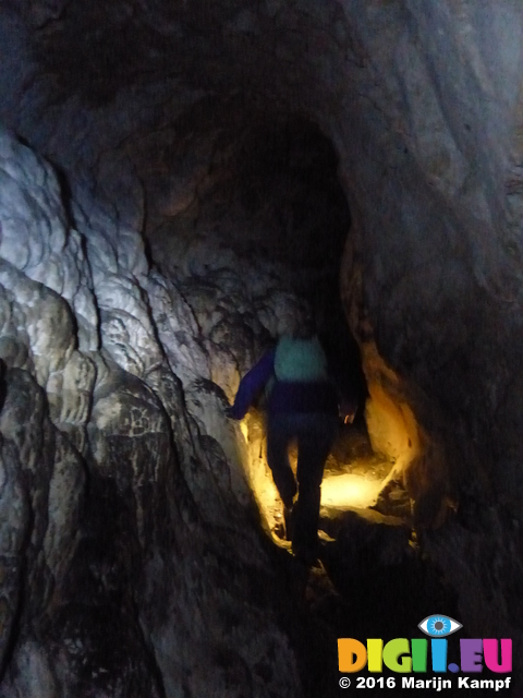 FZ025922 Jenni walking in Carreg Cennen Castle cave